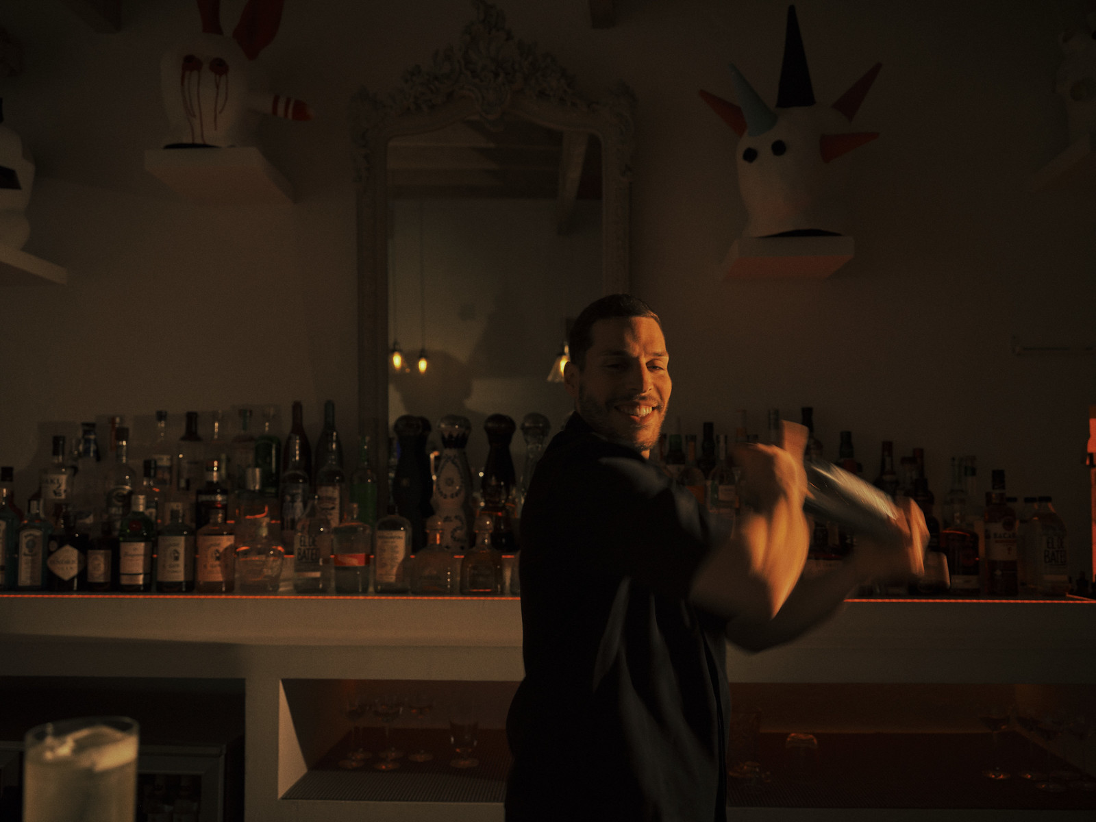 A bartender mixing a cocktail at the bar