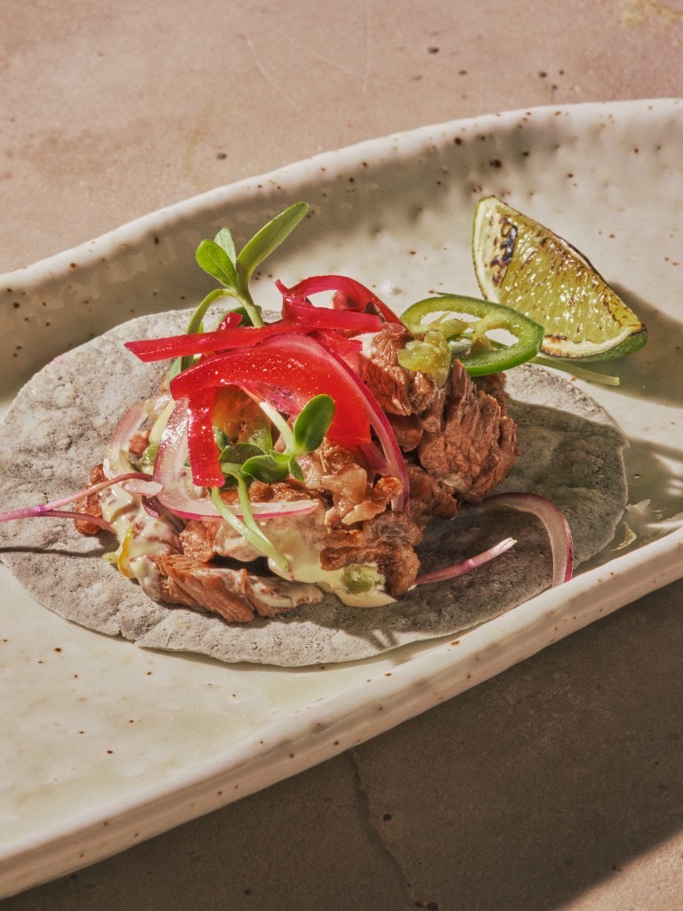 Beef taco on a blue corn tortilla