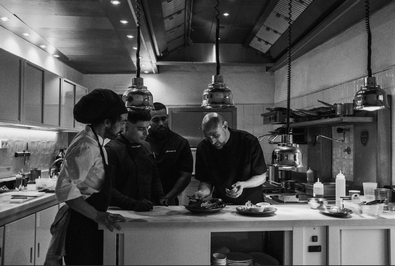 The kitchen team plating dishes at the pass